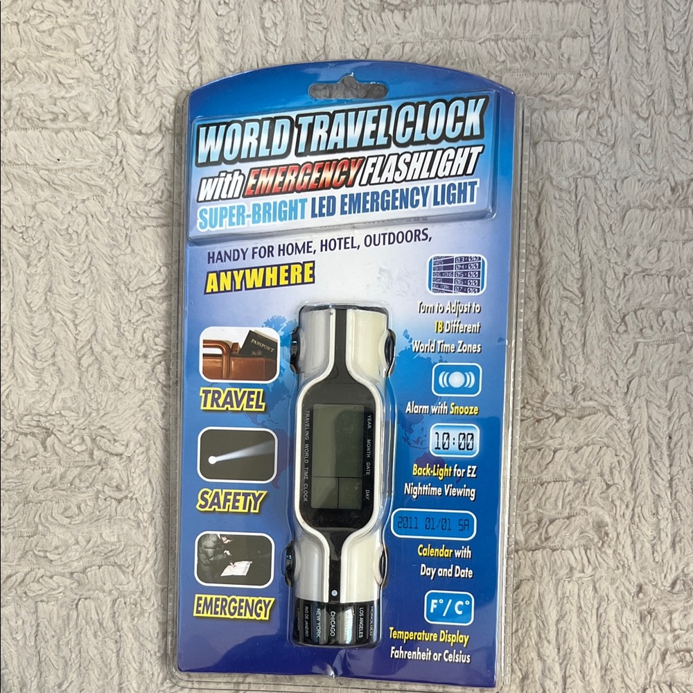 World travel clock with emergency flashlight. Super-bright LED emergency light